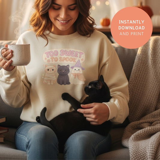 Cozy sweatshirt with “Too Sweet to Spook” PNG design – cute Halloween cats and ghost printable for apparel and fall fashion.