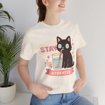 Model wearing pastel “Stay Hydrated” t-shirt by Ruby Bloom — aesthetic kawaii cat tee with a cozy vibe, perfect for artists, dreamers, and self-care lovers.