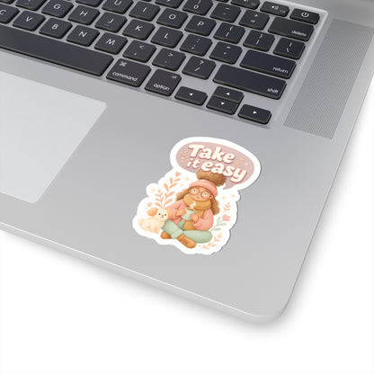 Take It Easy vinyl sticker 3x3 inches on laptop, cozy autumn design with girl, dog, and fall leaves.