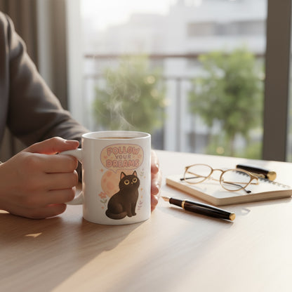 Coffee mug featuring printable Follow Your Dreams Black Cat PNG – cute Halloween sublimation design for cozy fall vibes, instant download.