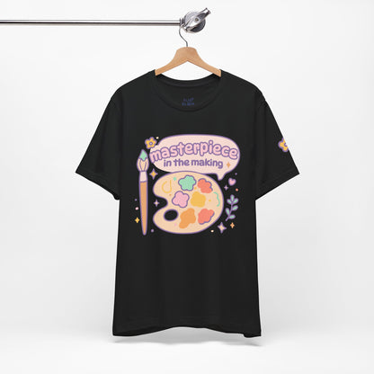 Black “Masterpiece in the Making” t-shirt with pastel print — dreamy artistic tee for creative souls, cozy outfit idea for art lovers.