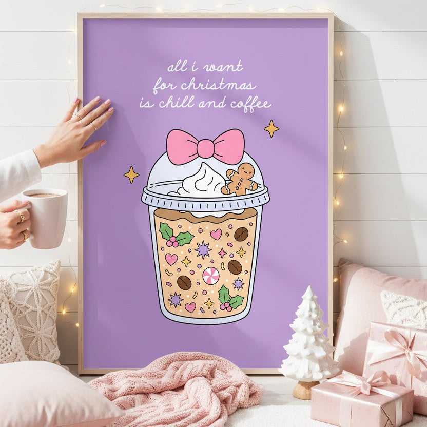 A framed art print featuring a Christmas-themed iced coffee cup with a gingerbread cookie and the text 'all i want for christmas is milk and coffee' on a lavender background, styled in a cozy bedroom setting with a pink blanket, pillows, and gift boxes.