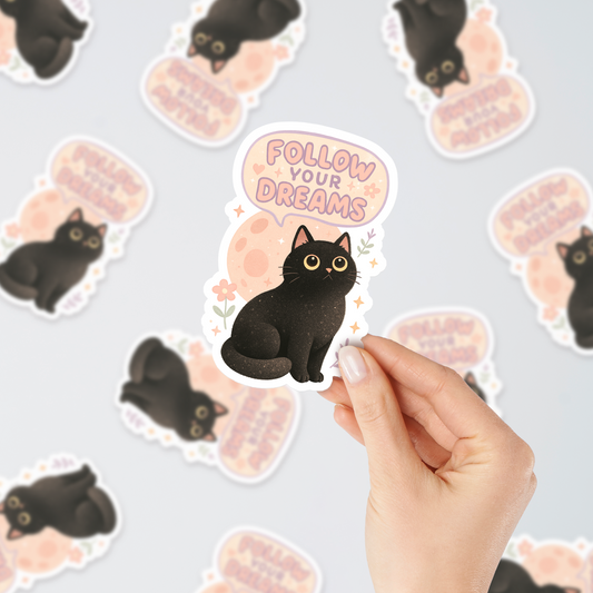 Black cat sticker with “Follow Your Dreams” text – durable vinyl sticker for laptops, water bottles, journals, and aesthetic decor.